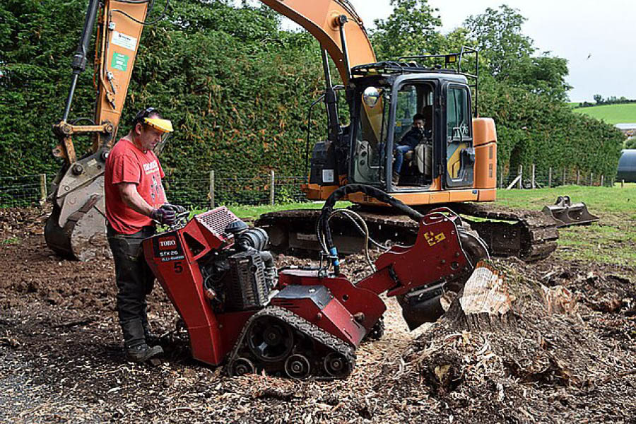 A qualified professional operating a Tree Stump Removal machine in Devon